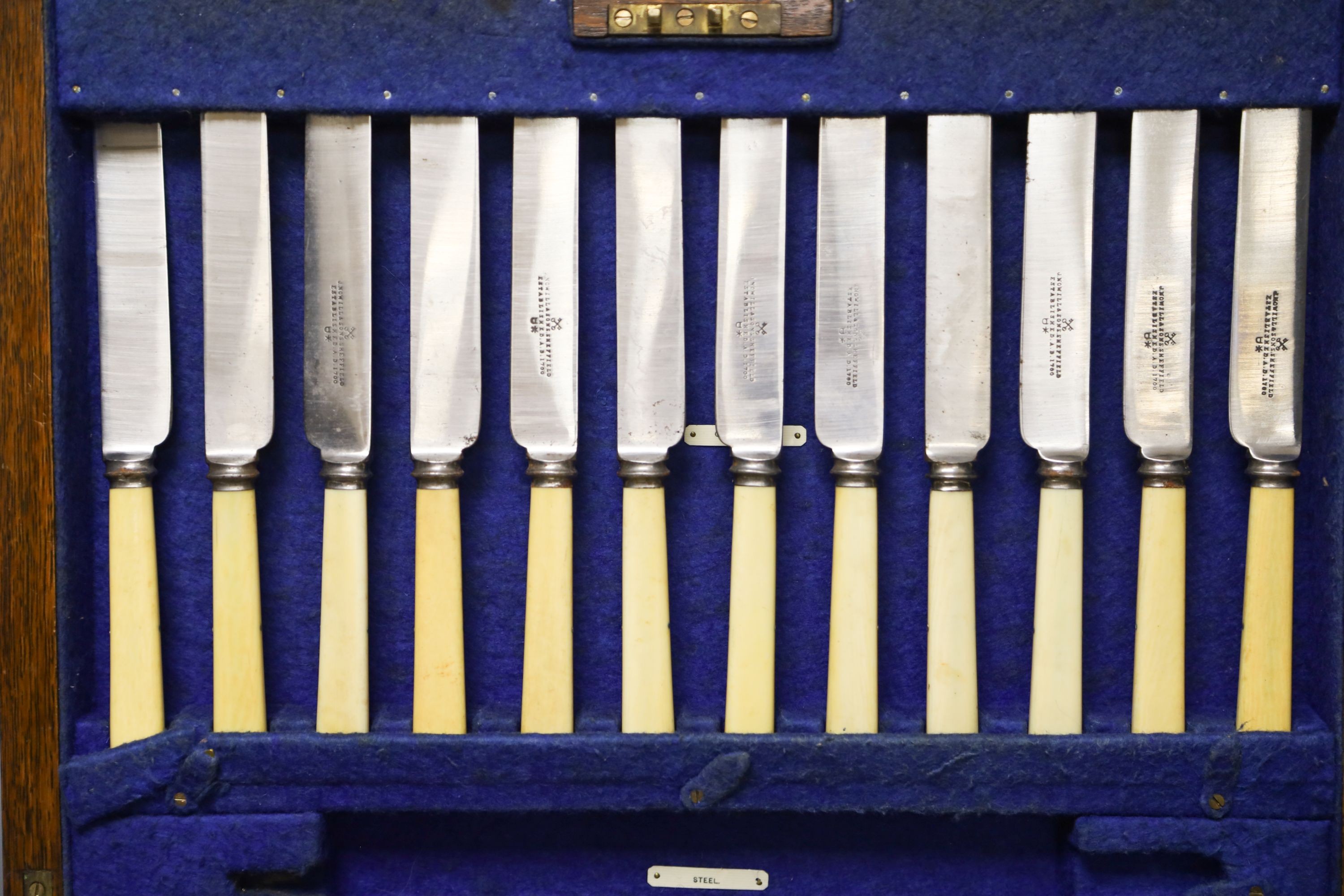 An Edwardian oak cased canteen of plated Kings pattern cutlery